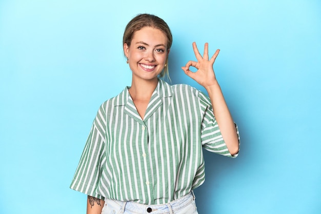 Young caucasian woman expressing emotions isolated on blue