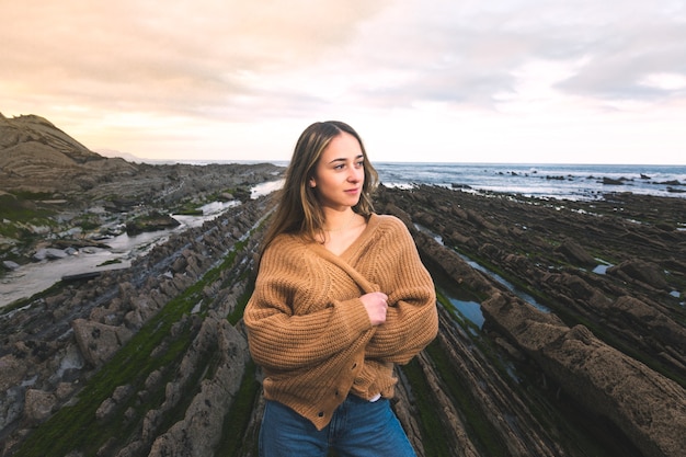 Young caucasian woman at the flysch geopark at the Basque Country.