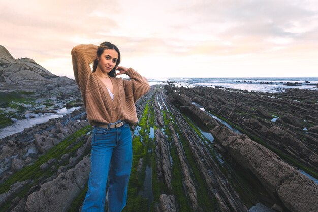 Young caucasian woman at the flysch geopark at the Basque Country.