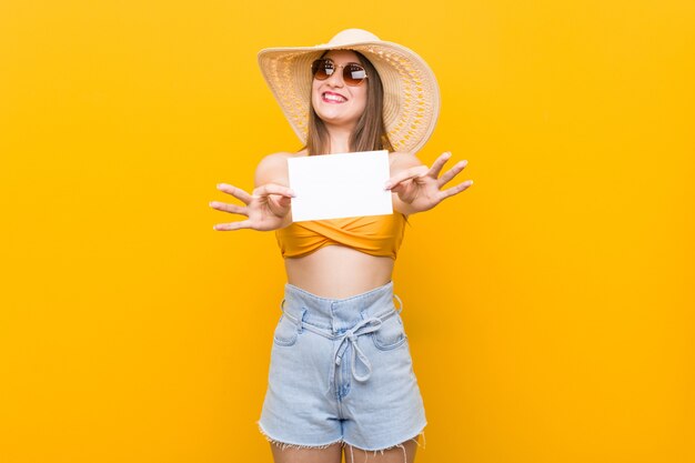 Young caucasian woman going to shopping Young caucasian woman ready to go to the beach with a placard