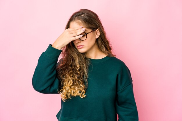 Young caucasian woman having a head ache, touching front of the face.