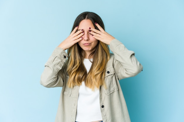 Young caucasian woman having a head ache, touching front of the face.