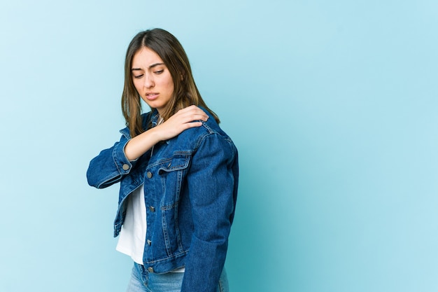 Young caucasian woman having a shoulder pain.