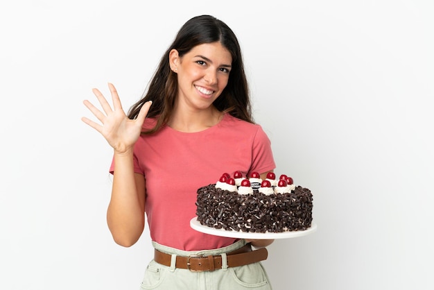 Young caucasian woman holding birthday cake isolated on white background counting five with fingers