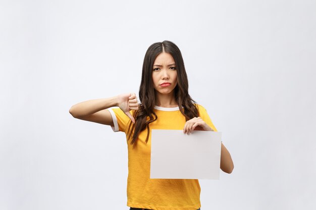 Young caucasian woman holding blank paper sheet