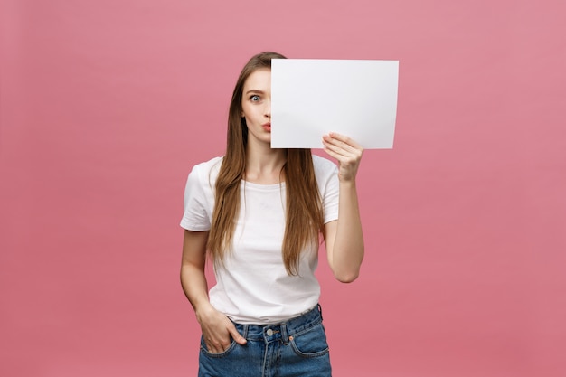 Young caucasian woman holding blank paper sheet