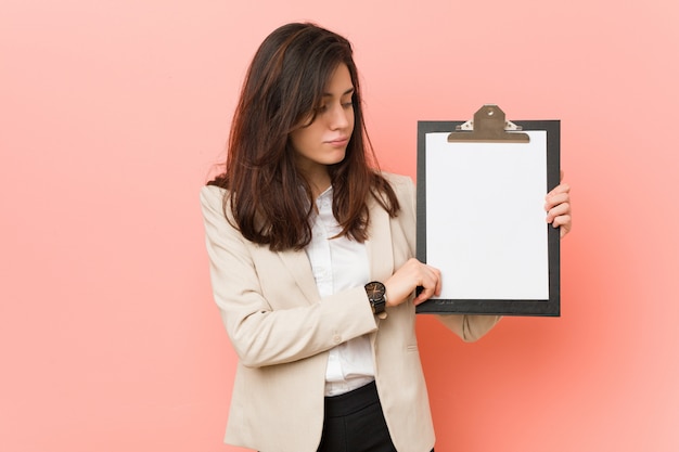 Young caucasian woman holding a clipboard