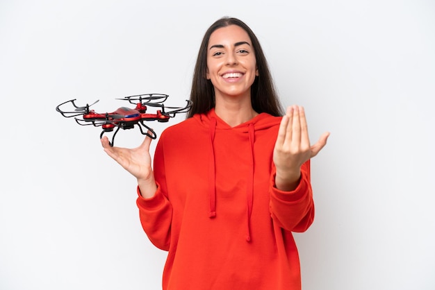 Young caucasian woman holding a drone isolated on white background