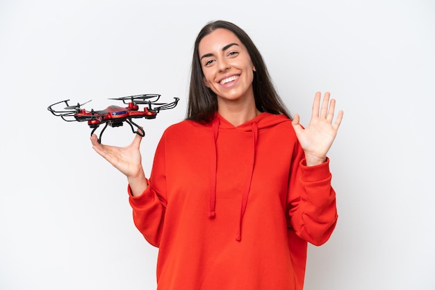 Young caucasian woman holding a drone isolated on white background