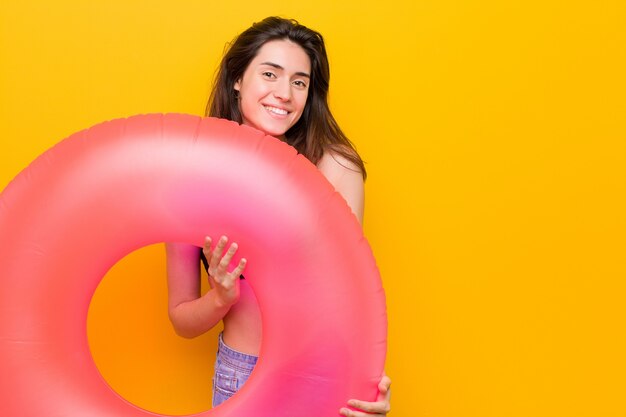 Young caucasian woman holding a float