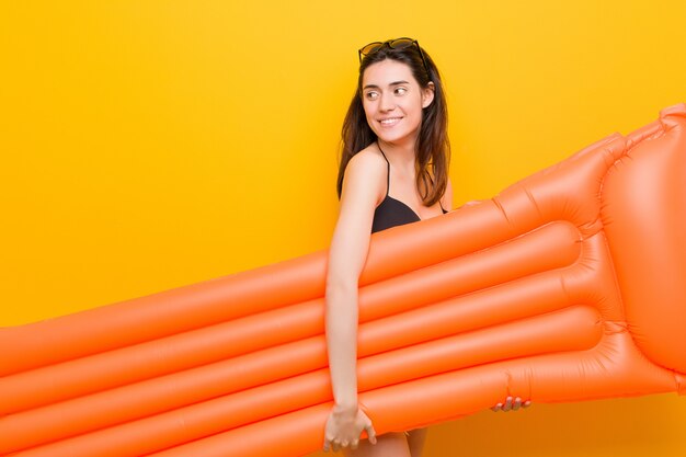 Young caucasian woman holding a float