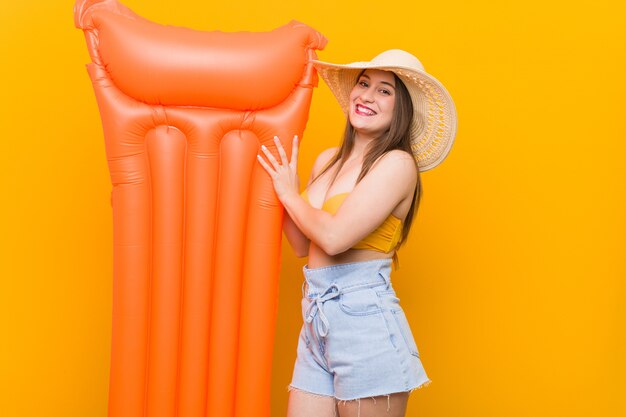 Young caucasian woman holding a floater