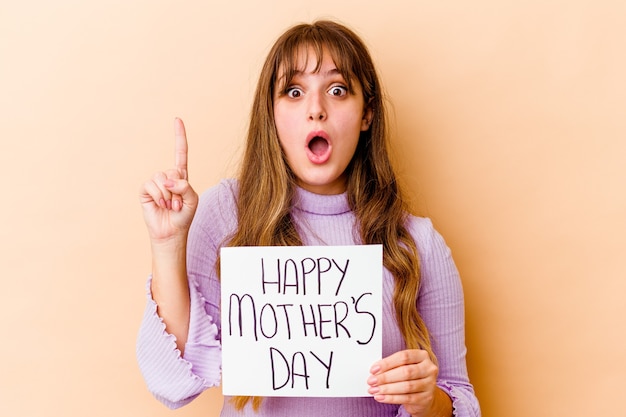 Young caucasian woman holding a Happy mothers day placard isolated having some great idea, concept of creativity.