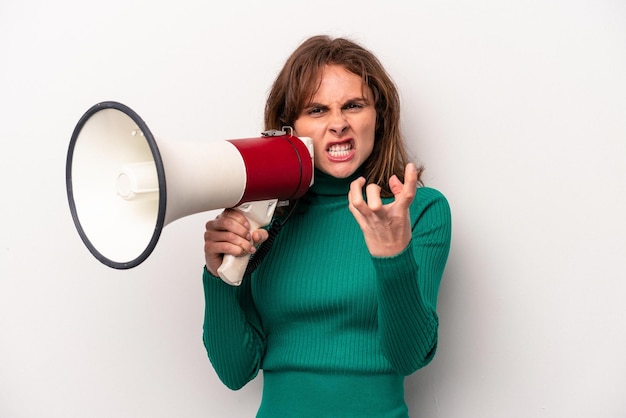 Young caucasian woman holding a megaphone isolated on white background