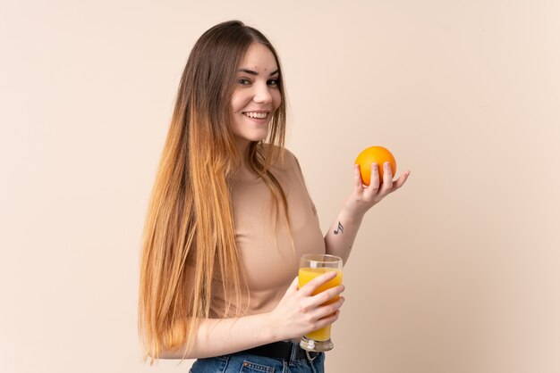 Young caucasian woman holding an orange