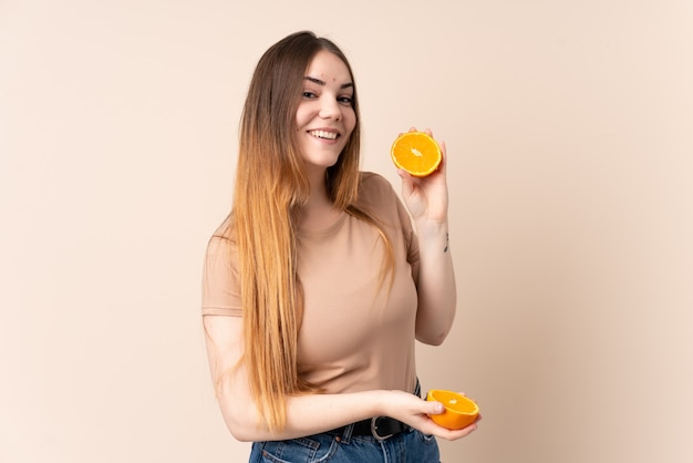 Young caucasian woman holding an orange