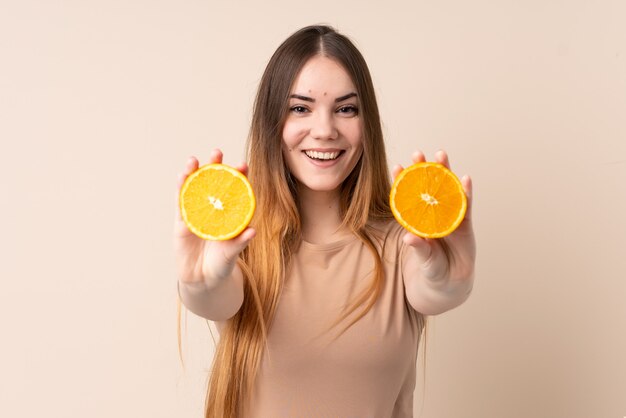 Young caucasian woman holding an orange