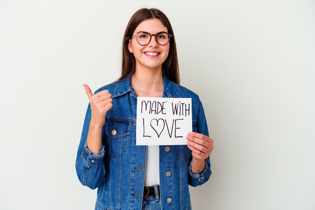 Young caucasian woman holding paper sheet with text: made with love