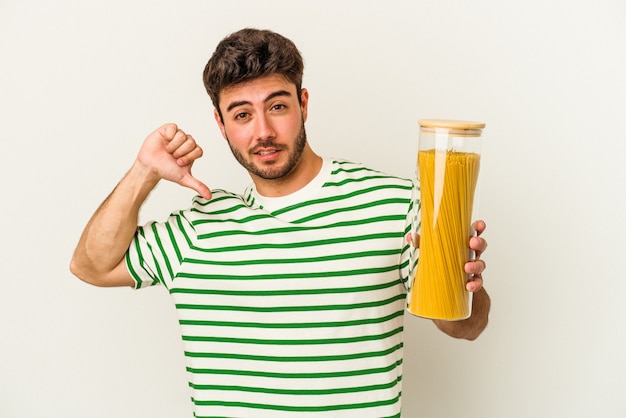 Young caucasian woman holding pasta jar isolated on white background feels proud and self confident, example to follow.