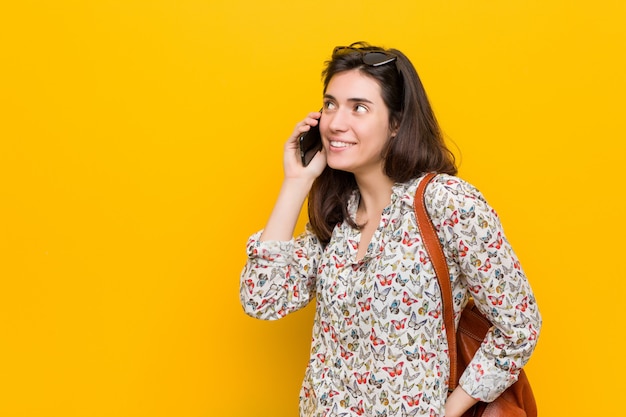 Young caucasian woman holding a phone