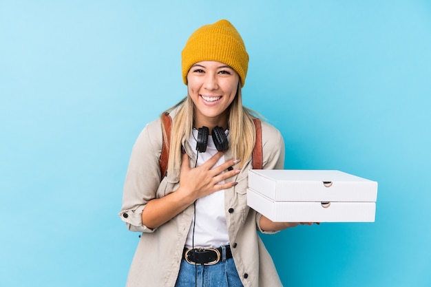 Young caucasian woman holding pizza
