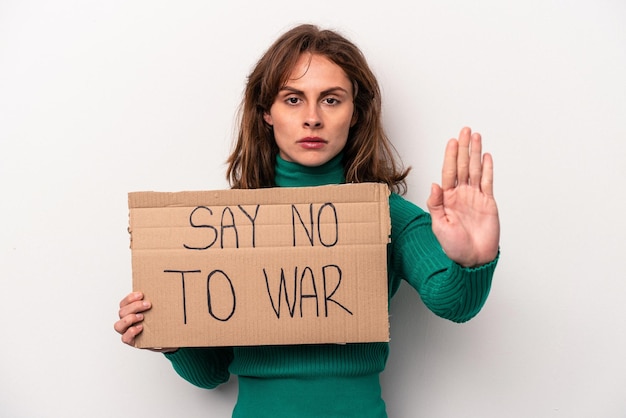 Young caucasian woman holding say no war placard isolated on white background