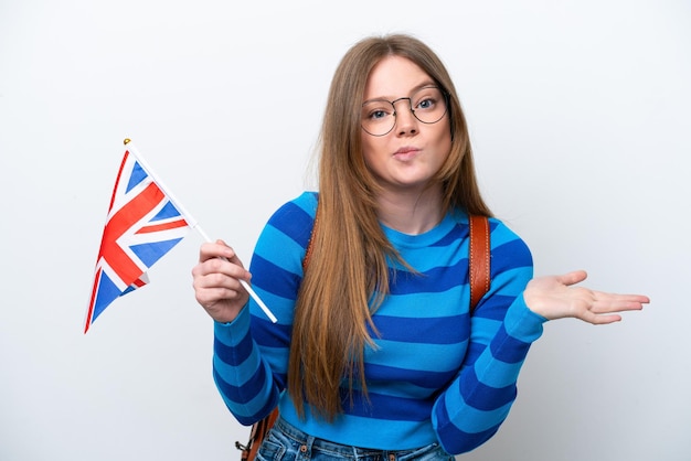 Young caucasian woman holding an United Kingdom flag isolated on white background