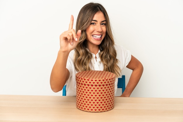 Young caucasian woman holding a valentines day box isolated having an idea, inspiration concept.