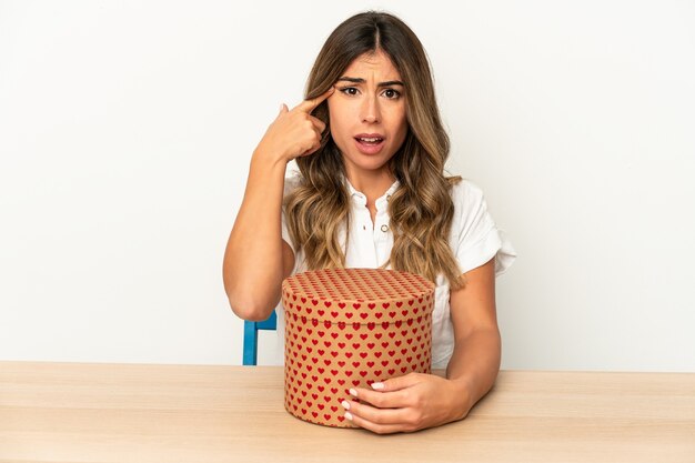 Young caucasian woman holding a valentines day box