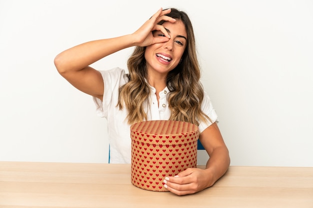 Young caucasian woman holding a valentines day box