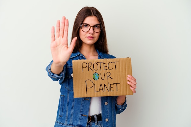 Young caucasian woman holding a vegan life placard isolated on white background receiving a pleasant surprise, excited and raising hands.