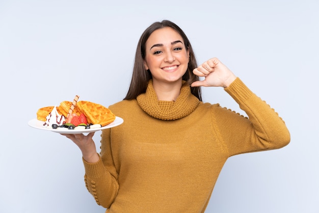 Young caucasian woman holding waffles