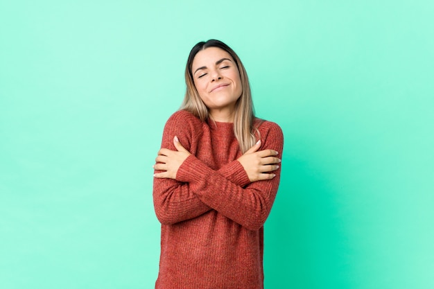 Young caucasian woman hugs, smiling carefree and happy.