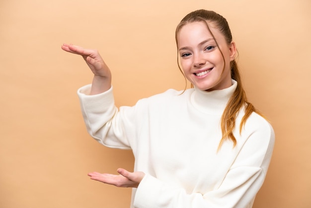 Young caucasian woman isolated on beige background holding copyspace to insert an ad