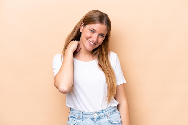 Young caucasian woman isolated on beige background laughing