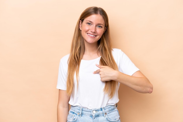 Young caucasian woman isolated on beige background with surprise facial expression