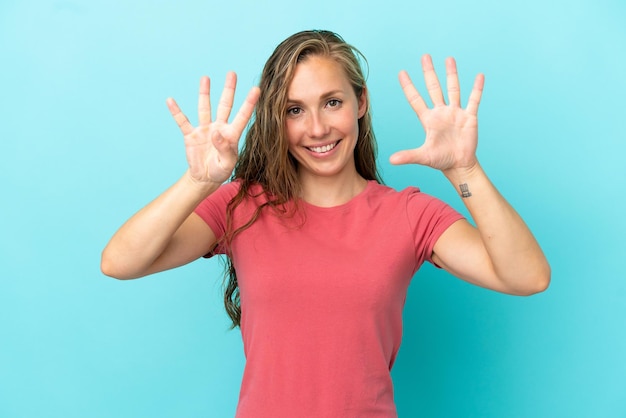 Young caucasian woman isolated on blue background counting nine with fingers