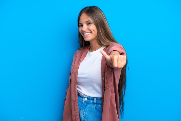 Young caucasian woman isolated on blue background giving a thumbs up gesture