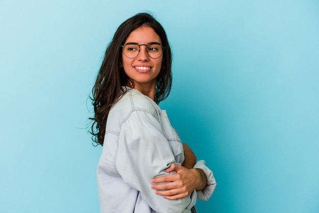 Young caucasian woman isolated on blue background laughing and having fun.