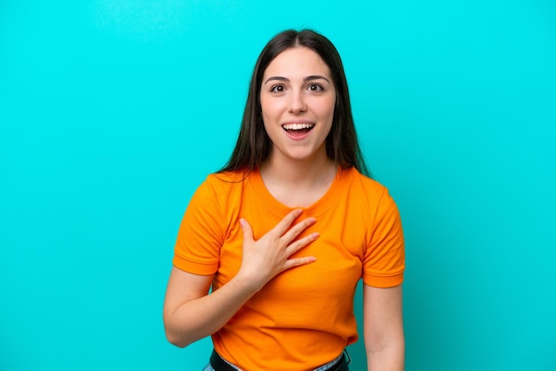 Young caucasian woman isolated on blue background pointing to oneself