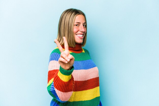 Young caucasian woman isolated on blue background showing number two with fingers