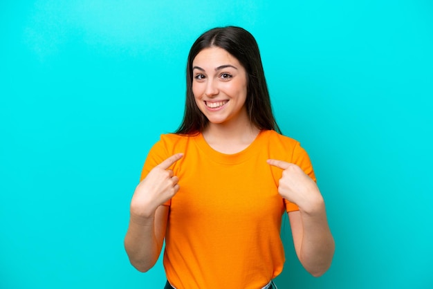 Young caucasian woman isolated on blue background with surprise facial expression