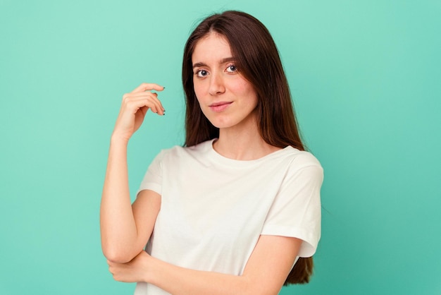 Young caucasian woman isolated on blue background