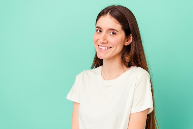 Young caucasian woman isolated on blue background