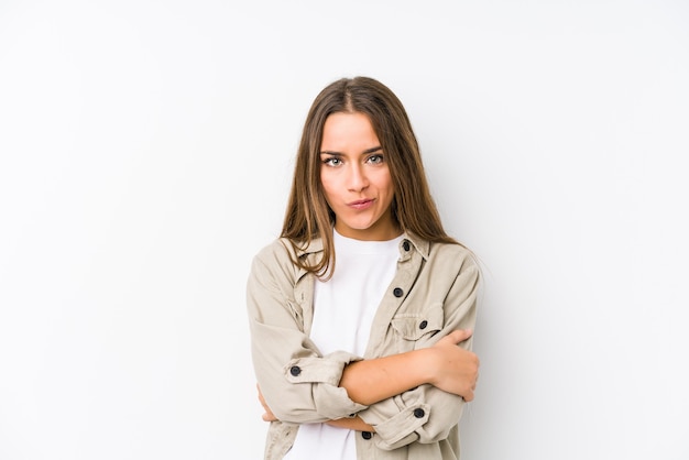 Young caucasian woman  isolated frowning face in displeasure, keeps arms folded.