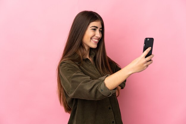 Young caucasian woman isolated making a selfie