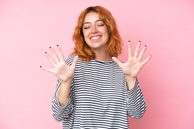 Photo young caucasian woman isolated on pink background counting ten with fingers