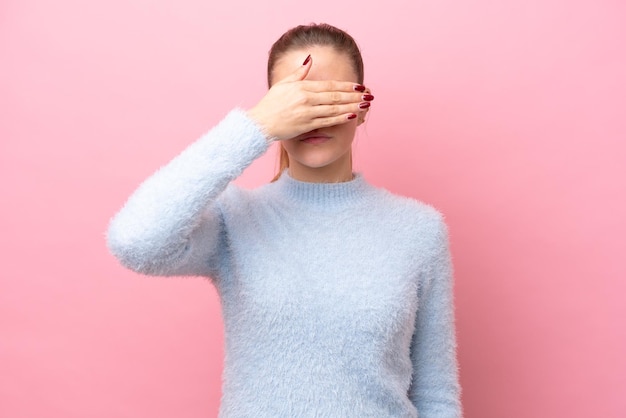 Young caucasian woman isolated on pink background covering eyes by hands Do not want to see something