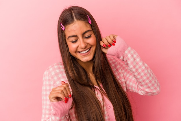 Young caucasian woman isolated on pink background dancing and having fun.