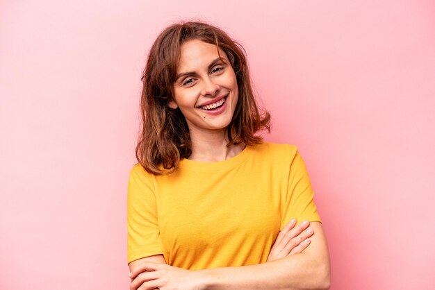 Young caucasian woman isolated on pink background happy smiling and cheerful